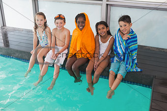 Cute little kids sitting poolside
