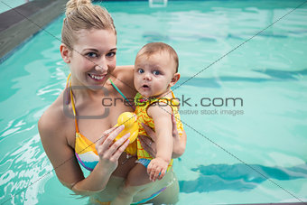 Pretty mother and baby at the swimming pool