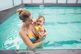 Pretty mother and baby at the swimming pool