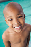 Cute little boy smiling at the pool