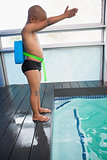 Little boy ready to dive in pool