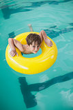 Little boy swimming with rubber ring