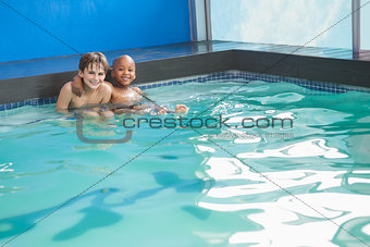 Little boys sitting in the pool