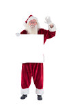 Santa holds a sign and is waving