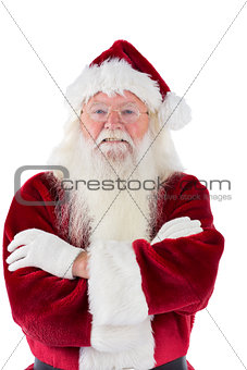 Santa smiles with folded arms