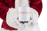 Santa holds a can for donations