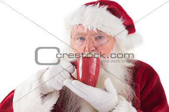 Santa drinks from a red cup