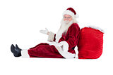 Santa sits leaned on his bag and has no clue