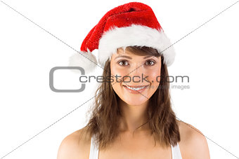 Brunette in santa hat smiling at camera