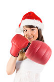Festive brunette punching with boxing gloves