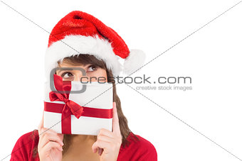 Portrait of a festive young woman holding a gift