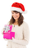 Smiling brunette opening christmas gift