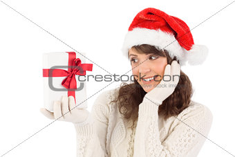 Pretty santa girl holding gift