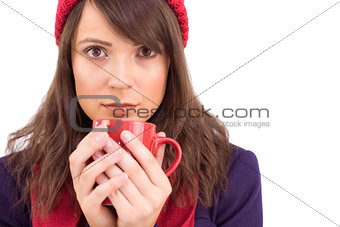 Serious young woman holding a mug