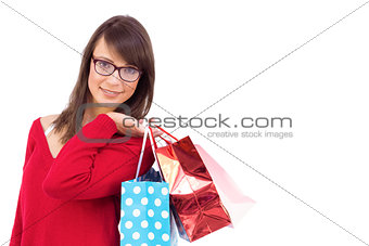 Happy brunette holding shopping bags