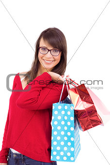 Smiling brunette holding shopping bags