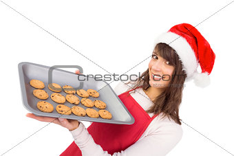 Brunette in santa hat offering hot cookies