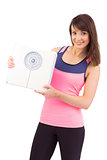 Smiling woman holding weighing scales
