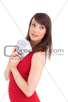 Festive brunette showing fan of dollars