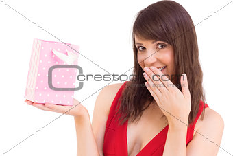 Festive brunette holding a gift bag