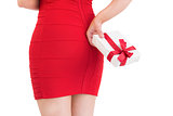 Woman in red dress holding gift