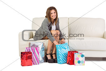Happy brunette opening gift bag