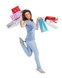 Smiling brunette jumping while holding shopping bags