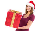 Pretty girl in santa hat holding gift box