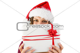 Festive brunette holding christmas present with bow