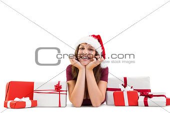 Festive brunette lying on the floor with gifts