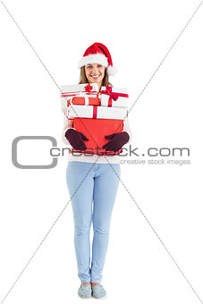 Festive young woman holding many gifts