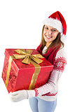 Young woman holding a gift while smiling at camera