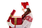 Smiling brunette in warm clothing opening a gift