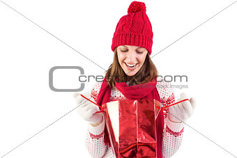 Smiling santa woman looking into shopping bag