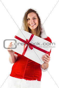 Pretty santa girl holding gift