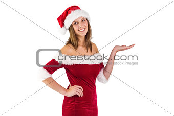 Pretty santa girl smiling at camera and presenting