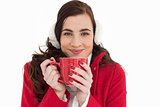 Woman in winter clothes enjoying a hot drink