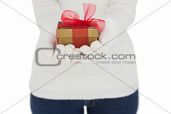 Woman in white gloves holding gift