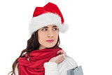Brunette in santa hat holding shopping bag