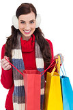 Brunette in winter clothes holding shopping bags