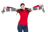Cheerful brunette holding scarf and spread her arms
