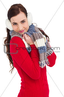 Pretty brunette in winter wear smiling at camera