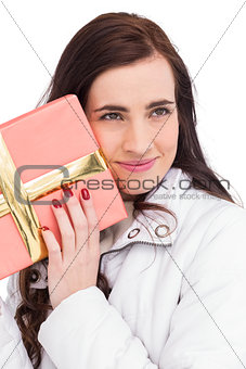 Portrait of a pretty brunette holding gift