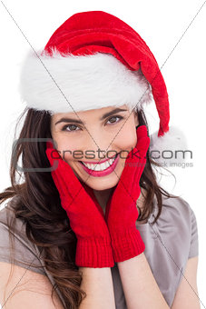 Portrait of a smiling brunette in santa hat