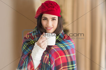 Brunette with cover holding mug
