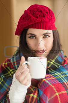 Brunette with cover holding mug