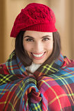 Smiling brunette with cover and red hat