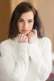 Brunette in white wool jumper posing
