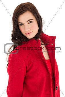 Portrait of a brunette in red coat posing
