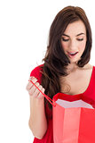 Brunette in red dress looking in shopping bag